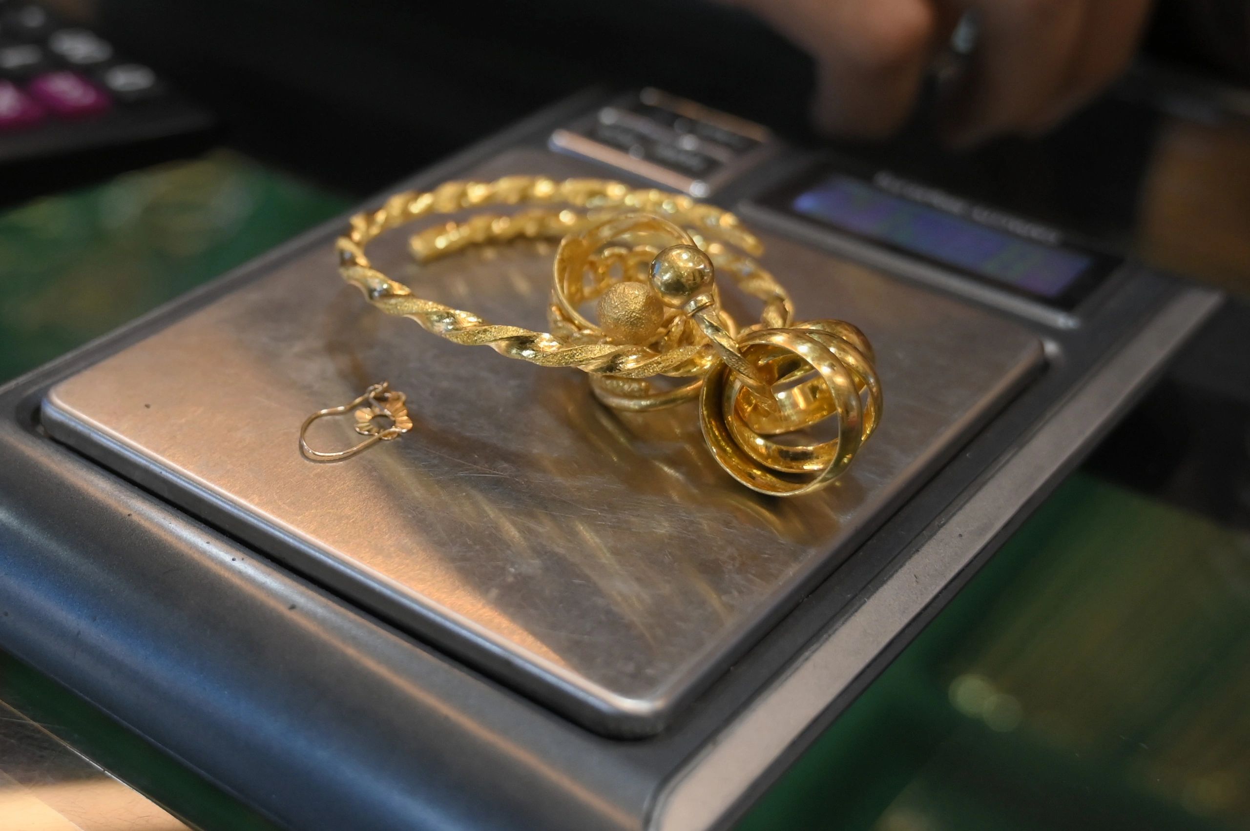 Close-up gold jewelry on scales